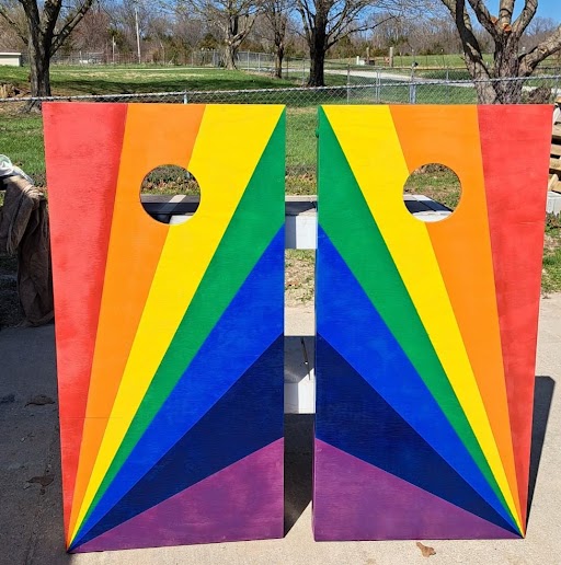 Image of two rainbow colored cornhole boards.