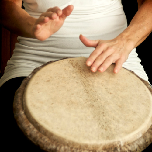Image of woman playing a drum