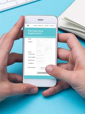 a person holding a phone filling out a membership application