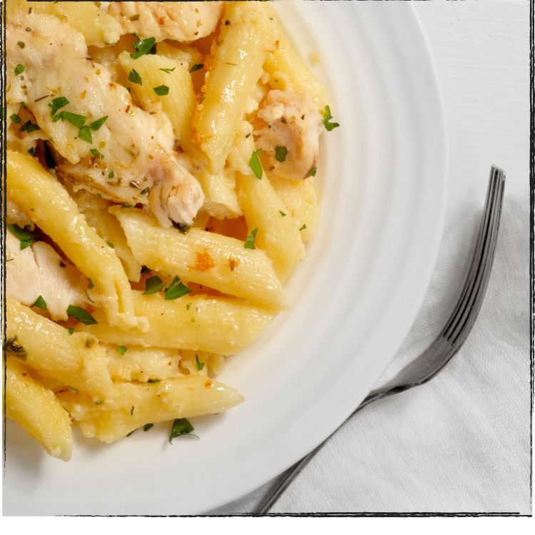 Penne pasta on plate with fork.