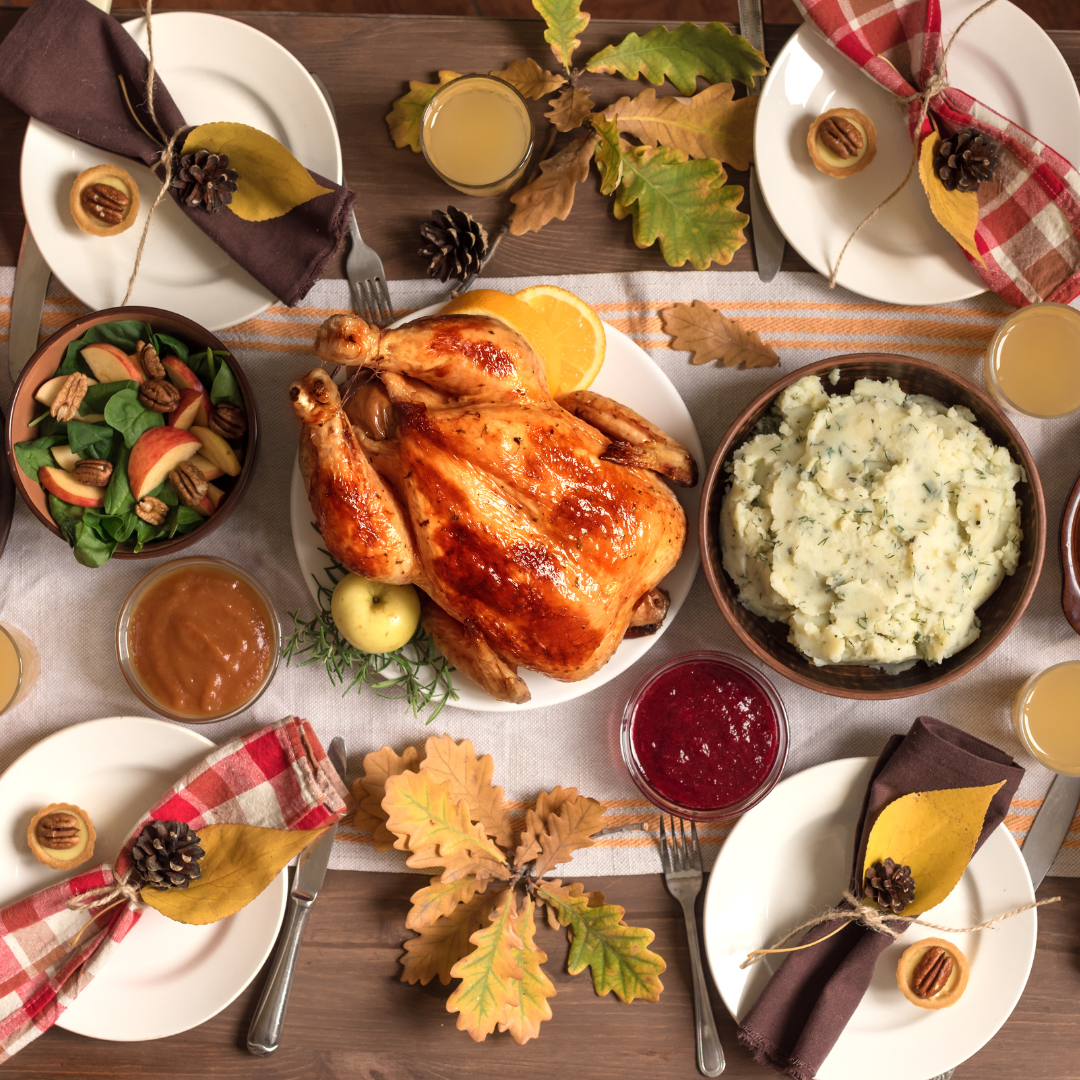image of a table filled with food traditionally associated with the colonizer holiday of thanksgiving