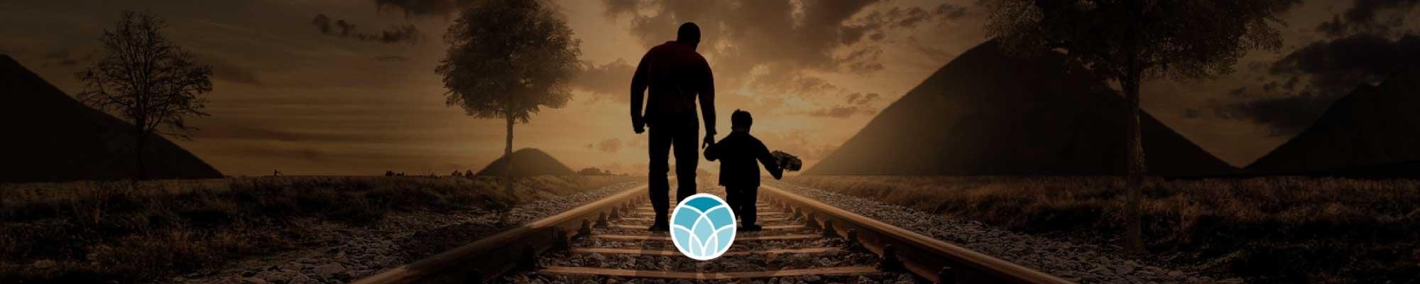 Image of an adult and child walking on railroad tracks with the Unity logo in the center.